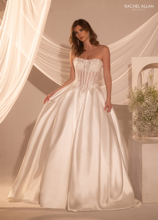 Model wearing a strapless wedding dress with a soft background